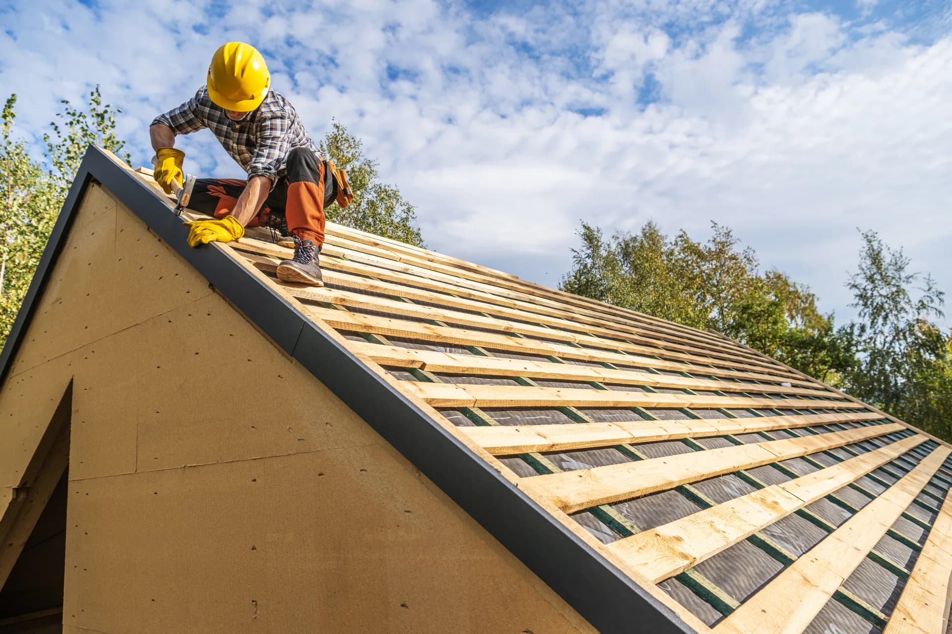 Professional roofer assembling roof structure